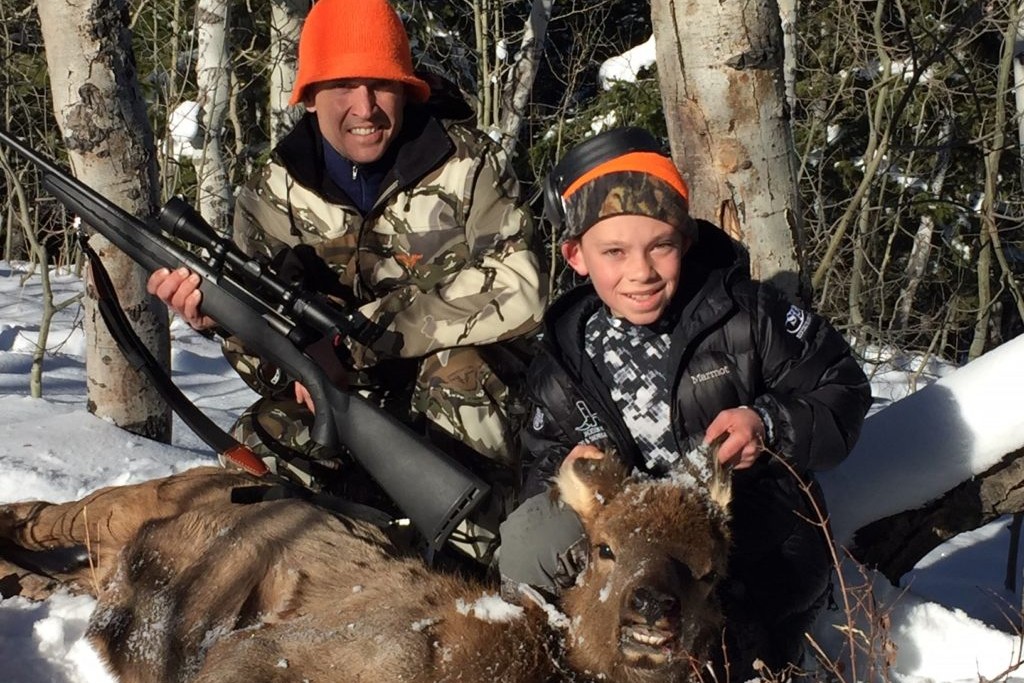 Hunter and his son with an elk