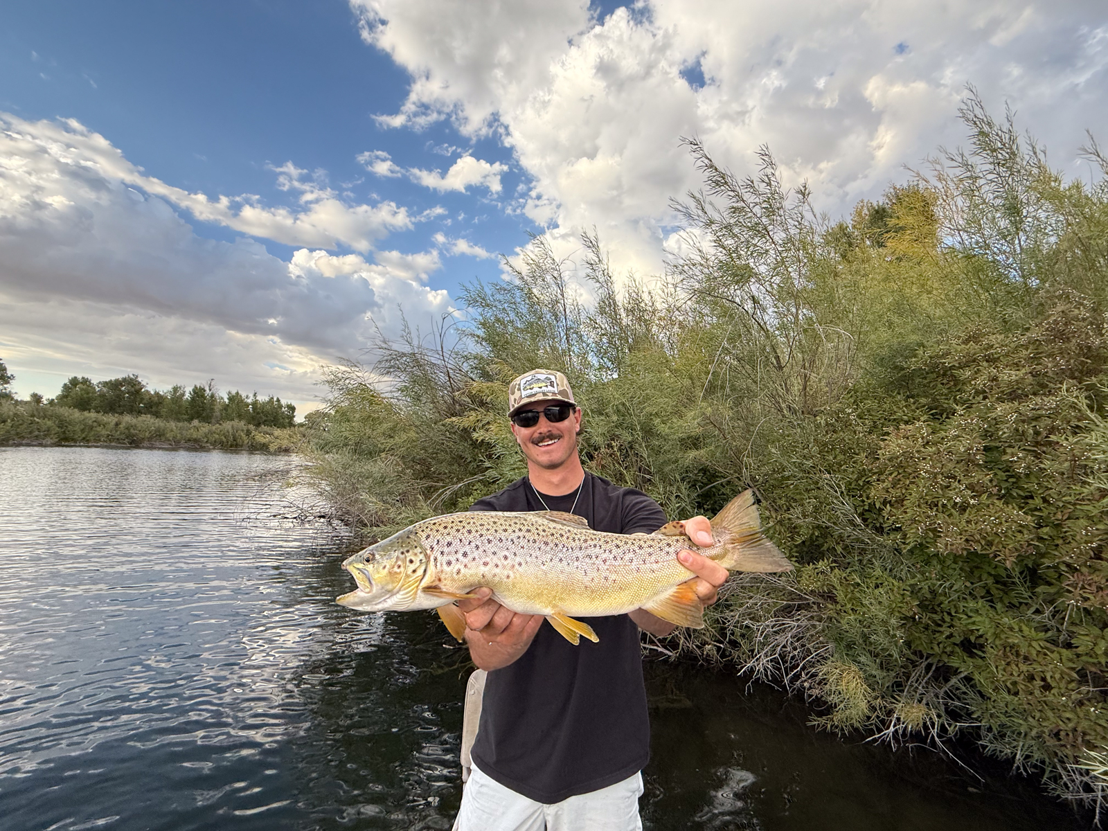fisherman holding caught fish