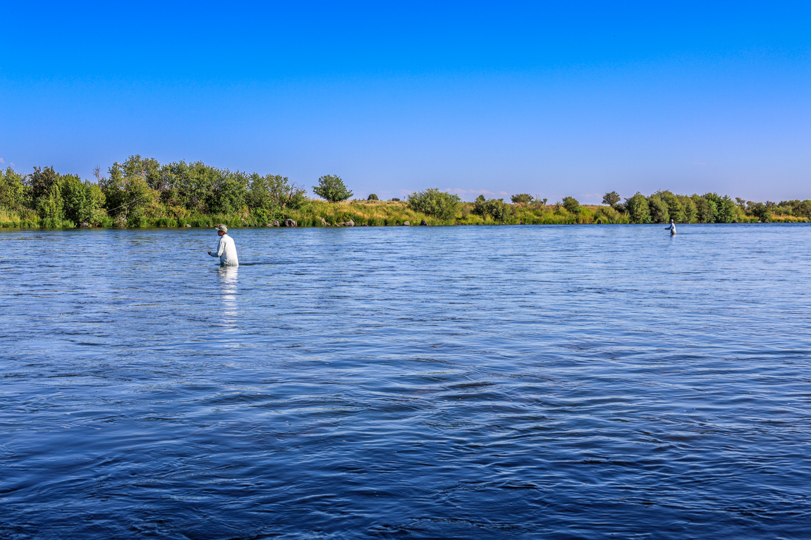 man fly fishing in river