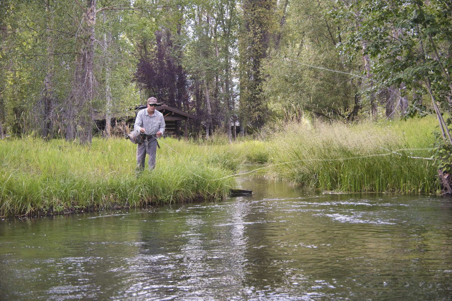 fisherman next to river
