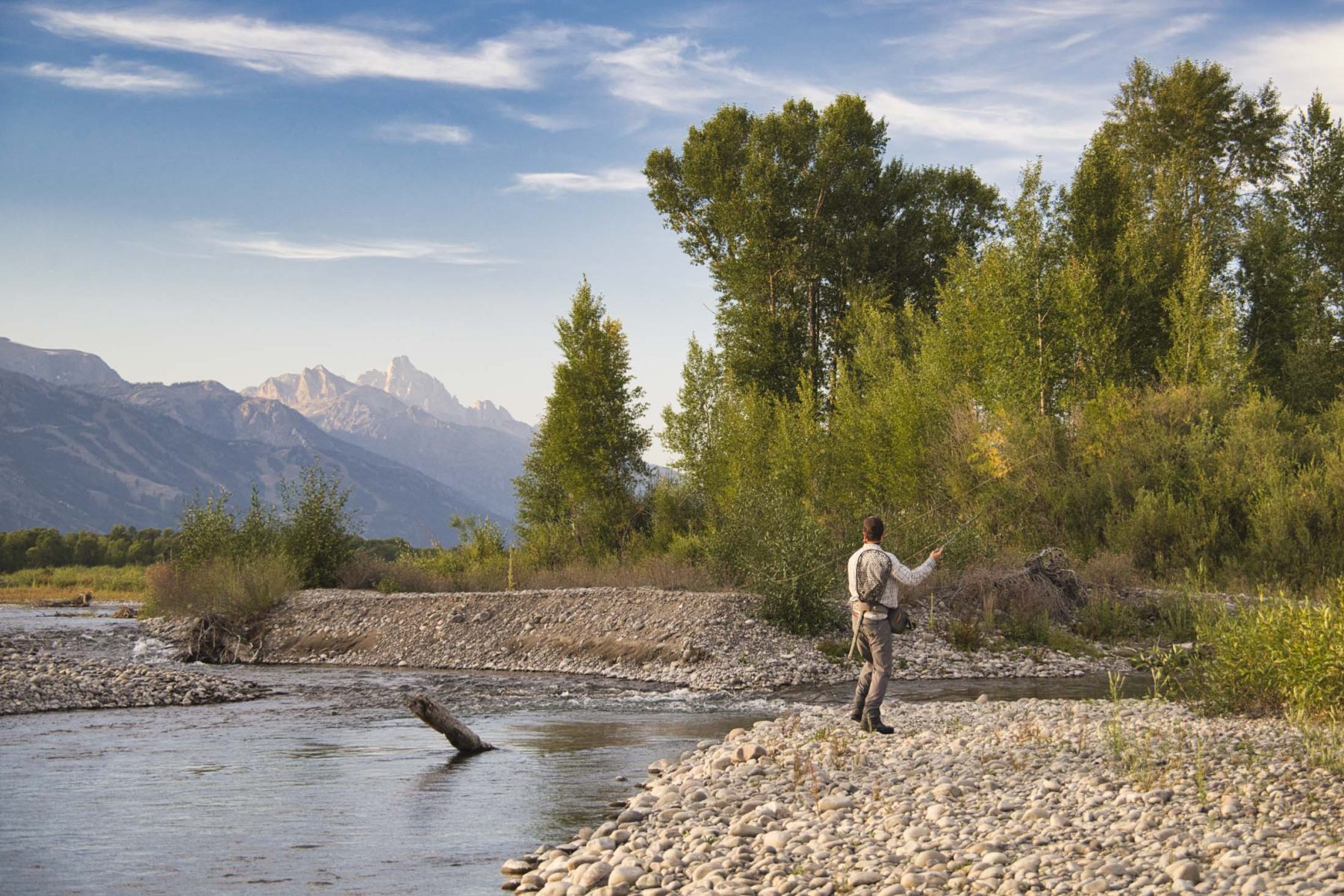 fisherman on riverfront ranch in Wyoming