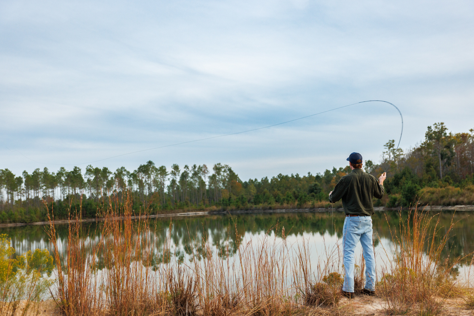 fisher next to pond