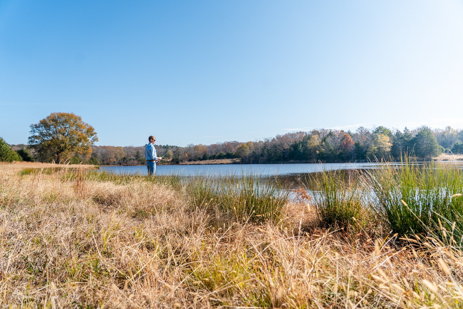 fisherman next to pond